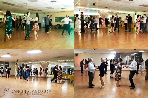 Groups of dancers enjoying a lively social dance event at Dancingland in April 2022, moving gracefully in a warmly lit dance studio.